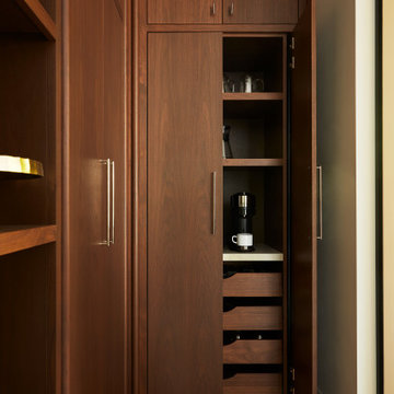 Walnut Pocket Doors Unveil a Stylish Kitchen Pantry Coffee Station