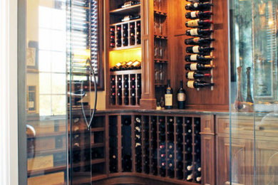 Example of a mid-sized classic dark wood floor wine cellar design in New York