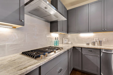 Eat-in kitchen - mid-sized contemporary l-shaped medium tone wood floor and brown floor eat-in kitchen idea in Austin with a single-bowl sink, shaker cabinets, gray cabinets, white backsplash, subway tile backsplash, stainless steel appliances, an island and quartzite countertops