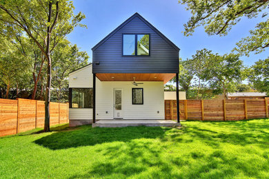 Small modern multicolored two-story concrete fiberboard exterior home idea in Austin with a shingle roof