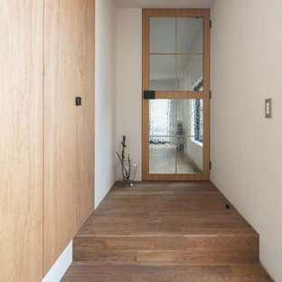 This is an example of a mid-sized shabby-chic style entry hall in Osaka with white walls, medium hardwood floors, a single front door, a medium wood front door and brown floor.