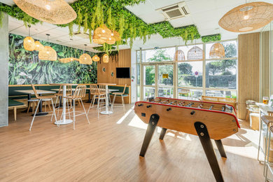 Inspiration pour une salle de séjour design en bois de taille moyenne et ouverte avec un mur blanc, parquet clair, aucune cheminée, un téléviseur fixé au mur et un sol beige.
