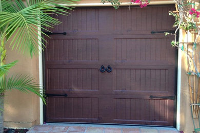 Insulated steel Garage Door with dark wood grain finish.