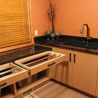 Design ideas for a medium sized world-inspired l-shaped separated utility room in Calgary with a submerged sink, flat-panel cabinets, light wood cabinets, granite worktops, orange walls, ceramic flooring and a side by side washer and dryer.