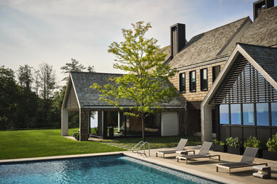 Example of a large trendy backyard stone and rectangular pool landscaping design in Chicago