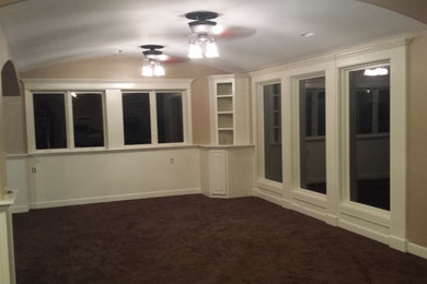 Basement - large modern walk-out carpeted basement idea in Kansas City with beige walls