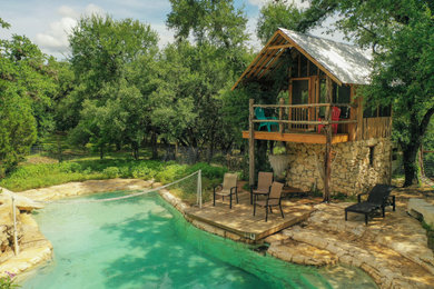 Mountain style backyard custom-shaped pool photo in Austin