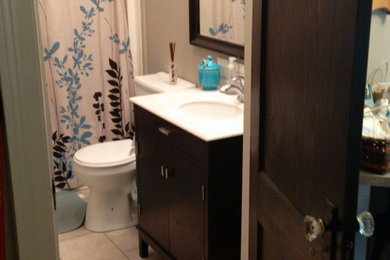 Example of a mid-sized classic master beige tile and porcelain tile bathroom design in Toronto with shaker cabinets, dark wood cabinets, a two-piece toilet, beige walls and granite countertops