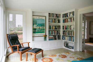 Large traditional enclosed living room in Other with white walls, ceramic floors, a library and no tv.