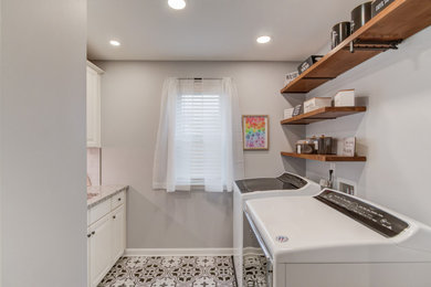 Mid-sized transitional ceramic tile laundry room photo in Atlanta with a single-bowl sink, granite countertops, gray backsplash, gray walls and a side-by-side washer/dryer
