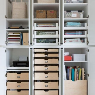 Design ideas for an expansive modern craft room in New York with a built-in desk.