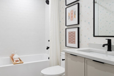 Alcove bathtub - mid-sized farmhouse kids' porcelain tile, beige floor, single-sink and wallpaper alcove bathtub idea in Vancouver with shaker cabinets, beige cabinets, a one-piece toilet, an undermount sink, quartzite countertops, white countertops and a built-in vanity