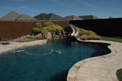 Mid-sized elegant backyard stone and custom-shaped natural pool photo