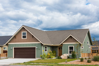 Mid-sized arts and crafts one-story mixed siding gable roof photo in Other