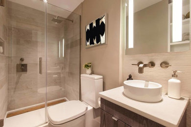Minimalist beige tile and porcelain tile porcelain tile bathroom photo in New York with flat-panel cabinets, dark wood cabinets, a one-piece toilet, gray walls, a console sink and quartz countertops