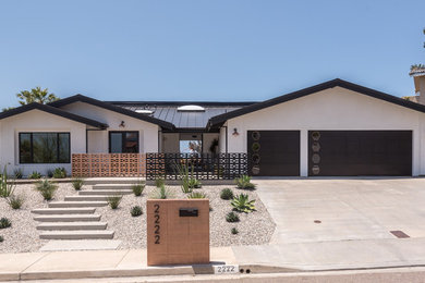 Large minimalist white one-story house exterior photo in San Diego with a metal roof