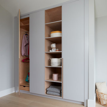 Light Grey Bedroom Closet with White Oak Interiors & Closet Rods