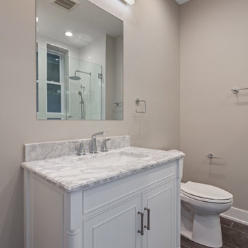 White and Brown Spacious Bathroom with Shower and Large Mirror (close look)