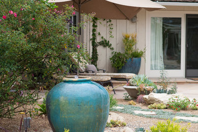 Design ideas for a large transitional drought-tolerant and partial sun backyard stone water fountain landscape in Los Angeles.