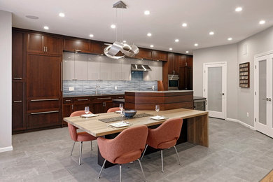 Large contemporary single-wall open plan kitchen in DC Metro with a single-bowl sink, flat-panel cabinets, brown cabinets, quartz benchtops, blue splashback, ceramic splashback, stainless steel appliances, porcelain floors, with island, grey floor and black benchtop.