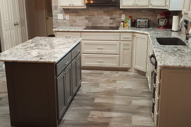 Inspiration for a large transitional u-shaped eat-in kitchen in Dallas with an undermount sink, shaker cabinets, white cabinets, granite benchtops, grey splashback, subway tile splashback, stainless steel appliances, ceramic floors and with island.