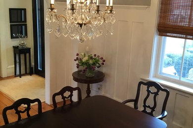 Mid-sized elegant medium tone wood floor enclosed dining room photo in Toronto with gray walls and no fireplace
