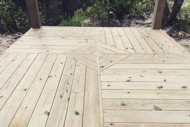 Mid-sized mountain style backyard deck photo in Miami with a roof extension