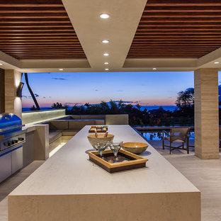 Ejemplo de cocina en L, actual, grande, abierta, con encimera de mármol, una isla, armarios con paneles lisos, puertas de armario en acero inoxidable, salpicadero beige, salpicadero de azulejos de cerámica, electrodomésticos de acero inoxidable, suelo de baldosas de porcelana y suelo beige