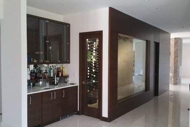 This is an example of a large contemporary wine cellar in Miami with marble floors, display racks and white floor.