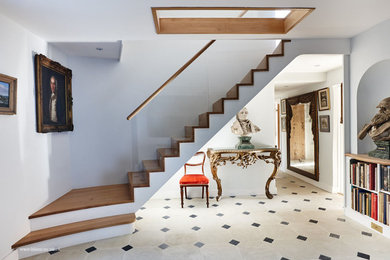 Mid-sized contemporary wood straight staircase in London with wood risers.