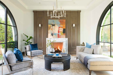 Design ideas for a mediterranean formal living room in Dallas with white walls, light hardwood floors, a standard fireplace, a stone fireplace surround and no tv.