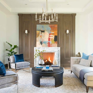 Design ideas for a mediterranean formal living room in Dallas with white walls, light hardwood flooring, a standard fireplace, a stone fireplace surround and no tv.