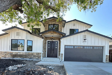 Inspiration for a farmhouse white two-story wood and board and batten exterior home remodel in San Francisco with a shingle roof and a black roof