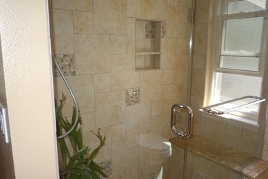 Example of a mid-sized classic corner shower design in Denver with beige walls