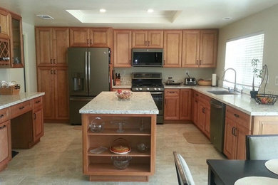 Open concept kitchen - mid-sized traditional u-shaped porcelain tile and gray floor open concept kitchen idea in Orange County with an undermount sink, raised-panel cabinets, light wood cabinets, quartz countertops, multicolored backsplash, stainless steel appliances and an island