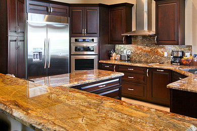 Inspiration for a mid-sized timeless u-shaped ceramic tile eat-in kitchen remodel in Miami with a drop-in sink, raised-panel cabinets, dark wood cabinets, granite countertops, multicolored backsplash, stone slab backsplash, stainless steel appliances and an island