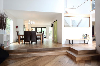 Example of a large minimalist light wood floor kitchen/dining room combo design in Vancouver with white walls