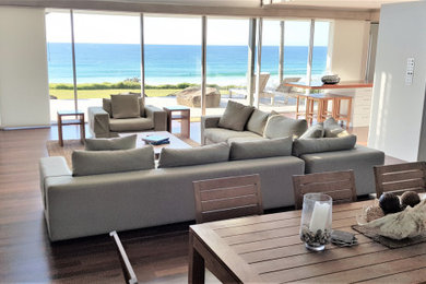 Design ideas for a beach style living room in Sunshine Coast with white walls.