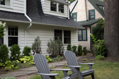 Example of a mid-sized transitional white two-story house exterior design in Minneapolis with a gambrel roof