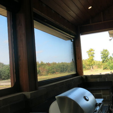 Motorized Retractable Screens In Upscale Hunting Lodge Outdoor Kitchen/Porch