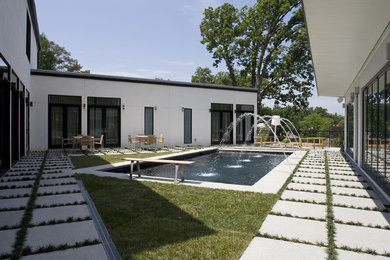 Mid-sized contemporary white one-story stucco flat roof idea in DC Metro