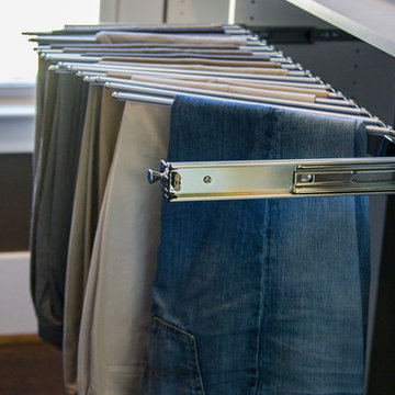 Slide-out pants hanger in closet