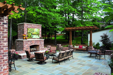Inspiration for a large timeless backyard stone patio remodel in Jackson with a fire pit and no cover