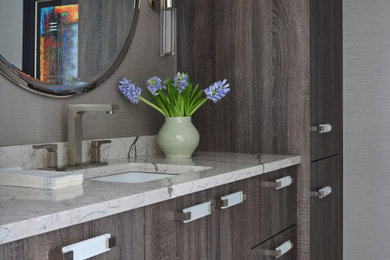 Large contemporary cloakroom in Chicago with flat-panel cabinets, brown cabinets, a one-piece toilet, grey walls, medium hardwood flooring, a submerged sink, engineered stone worktops, brown floors, white worktops, a floating vanity unit and wallpapered walls.
