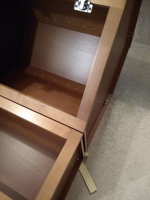 Attaching face frame of diagonal corner cabinet to straight cabinet ...