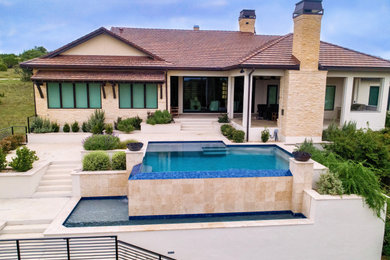 Pool - huge modern backyard concrete and rectangular infinity and privacy pool idea in Austin