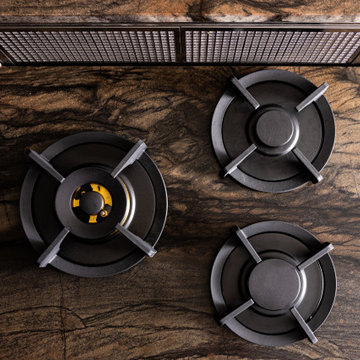 . Integrated Gas Burners in Dark Stone CountertopThree gas burners are integrate