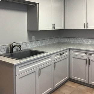 Design ideas for a medium sized farmhouse l-shaped separated utility room in Portland with a single-bowl sink, beaded cabinets, grey cabinets, granite worktops, grey walls, ceramic flooring, a side by side washer and dryer, pink floors and white worktops.