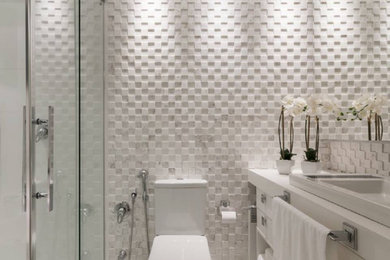 Exemple d'une salle de bain moderne de taille moyenne avec un placard à porte plane, des portes de placard blanches, un carrelage blanc, du carrelage en marbre, un sol blanc, une cabine de douche à porte coulissante et un plan de toilette blanc.