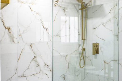 Example of a white tile and porcelain tile porcelain tile, white floor and double-sink bathroom design in Toronto with shaker cabinets, white cabinets, white walls, quartz countertops, a hinged shower door, white countertops and a niche